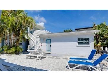 Charming exterior features beach access, outdoor seating and two lounge chairs, perfect for relaxing at 6610 Midnight Pass Rd # 11, Sarasota, FL 34242
