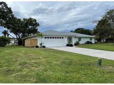 Charming single-story home featuring a well-manicured lawn and a two-car garage at 7912 Estates Dr, Sarasota, FL 34243