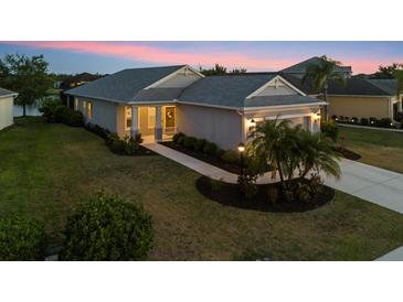 Charming single-story home with well-manicured lawn and inviting walkway leading to the front door at 12237 Longview Lake Cir, Bradenton, FL 34211