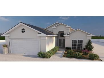 Charming home featuring a two-car garage and manicured landscaping that leads to a welcoming front entrance at 12541 Estrella Blvd, Punta Gorda, FL 33955