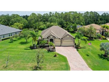 Well-maintained single-story home with a brick driveway and attached two-car garage at 15608 31St E St, Parrish, FL 34219