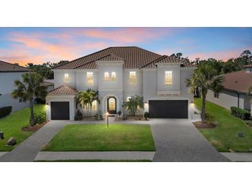 Elegant two-story home boasting lush landscaping, a tile roof, and a welcoming entryway at 3415 Big Sky Way, Bradenton, FL 34211