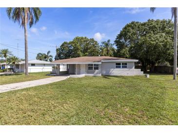 Quaint single-story home featuring a well-manicured lawn and covered carport at 4229 Alna Way, Sarasota, FL 34232