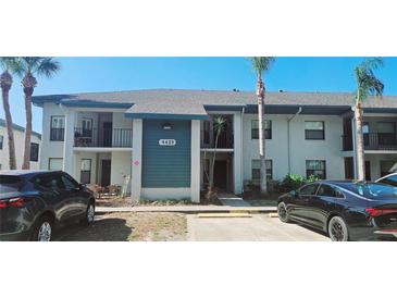 Two story condo building with palm trees and parking in front at 4415 45Th W Ave # 203, Bradenton, FL 34210