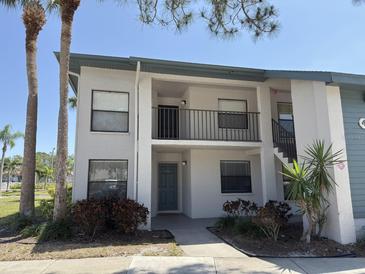 Two-story condo building showcasing a patio, neutral paint, and complemented by mature landscaping at 4505 45Th W Ave # 101B, Bradenton, FL 34210