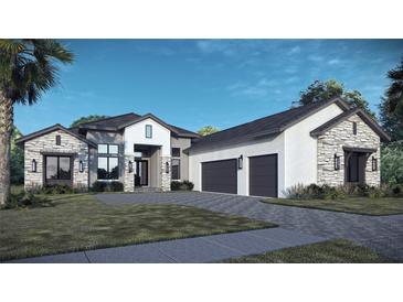Stunning home with a modern elevation, three-car garage, stone accents, and lush landscaping at 11157 Price Ln, Myakka City, FL 34251