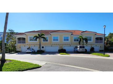 Mediterranean-style townhomes with tile roofs, garages, and well-maintained landscaping in a desirable neighborhood at 116 Navigation Cir # 106, Osprey, FL 34229