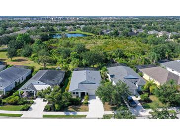Beautiful aerial view of homes showing the backyard pool and well maintained landscaping at 12133 Forest Park Cir, Bradenton, FL 34211