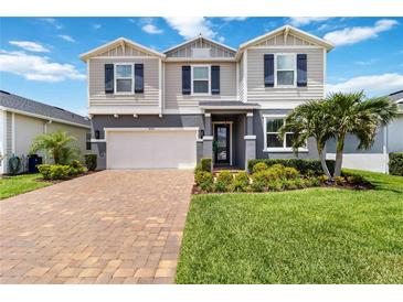 Charming two-story home with manicured lawn and paver driveway provides great curb appeal at 14363 59Th E Cir, Lakewood Ranch, FL 34211