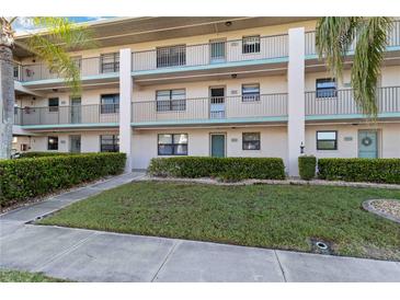 Three-story condo building has manicured landscaping, walkways, and private balconies at 175 Kings Hwy # B5, Punta Gorda, FL 33983