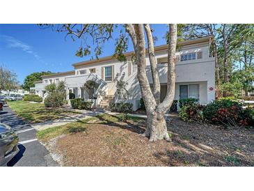 Charming townhome with stucco facade, lush landscaping, and a private entrance at 5269 Wedgewood Ln # 36, Sarasota, FL 34235