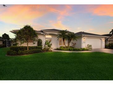 Charming single-story home boasting a well-manicured lawn, mature trees, and a two-car garage at 5782 Sandy Pointe Dr, Sarasota, FL 34233