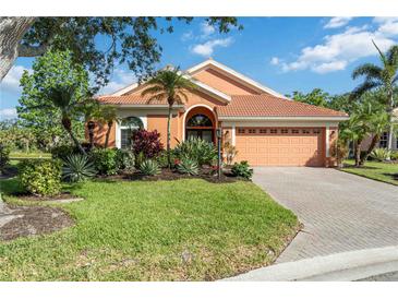 Charming home featuring a beautifully landscaped front yard and a brick driveway at 7231 Brambury Ct, Sarasota, FL 34238