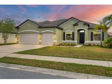 Charming single-story home with a well-manicured lawn and a three-car garage at 7418 61St E St, Palmetto, FL 34221