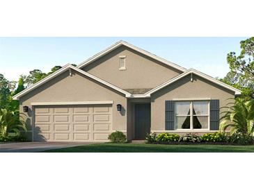 Charming single-story home showcasing a neutral stucco exterior, two-car garage, and well-maintained landscaping at 10844 Gentle Current Way, Parrish, FL 34219