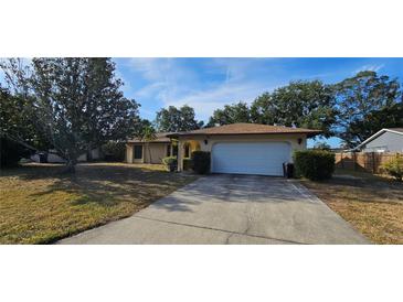 Single Gathering home features a large two-car garage and a well-kept lawn at 1218 Carmella Ln, Sarasota, FL 34243