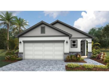 Charming single-story home with a two-car garage, stone accents, and landscaped front yard at 1848 Cobb Trl, Parrish, FL 34219