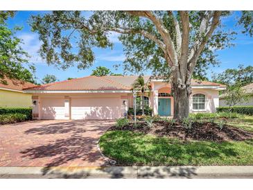 Charming single-story home featuring a tile roof, brick driveway, and mature landscaping at 4730 Old Farm Rd, Sarasota, FL 34233