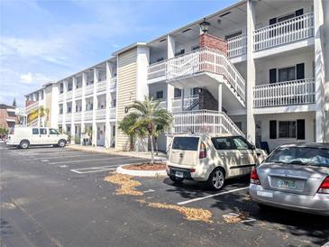 Condo building featuring well-maintained exteriors, parking, and community landscaping on a bright sunny day at 5951 Todd St # D37, Bradenton, FL 34207