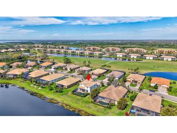 Beautiful aerial view of a home with pool in a golf community with lake views at 8603 River Preserve Dr, Bradenton, FL 34212