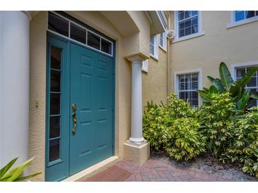 Inviting front door with decorative windows surrounded by lush landscaping at 927 River Basin Ct # 201C, Bradenton, FL 34212