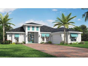 Beautiful single-story home featuring lush landscaping, a brick driveway, and charming turquoise accents on the windows and front door at 0 Jenny Dr, Nokomis, FL 34275