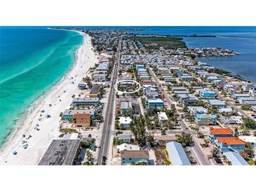 Stunning aerial view of a home near the beach with turquoise water, showcasing the ideal coastal living at 101 25Th N St # 1, Bradenton Beach, FL 34217