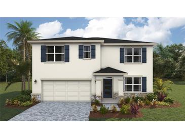 Two-story home features a two-car garage, blue shutters, a covered porch, and professionally landscaped yard at 1750 Cobb Trl, Parrish, FL 34219
