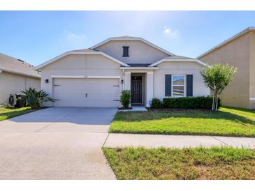 Charming single-story home features a well-manicured lawn and attached two-car garage at 309 Blue Point Dr, Ruskin, FL 33570
