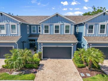 Attractive two-story townhome featuring a two-car garage and charming landscaping at 4548 Chinkapin Dr, Sarasota, FL 34232