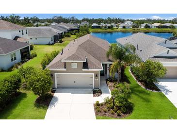 Charming single-Gathering home features a two-car garage, manicured landscaping, and a serene lake view in a friendly neighborhood at 4815 Deep Creek Ter, Parrish, FL 34219