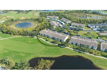 Gorgeous aerial view of the condo complex with a golf course and pond nearby at 9470 High Gate Dr # 2213, Sarasota, FL 34238