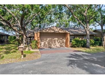 Charming home with mature trees, a two-car garage, and a neatly landscaped front yard at 1308 Willow Oak Cir, Bradenton, FL 34209