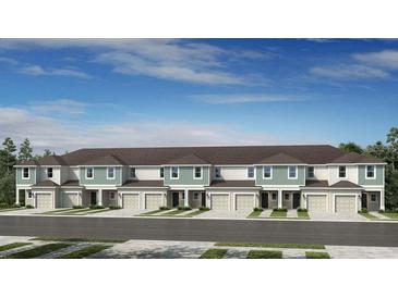 New townhomes with individual garages and manicured lawns under a bright blue sky at 15153 Cuzcorro Ct, Nokomis, FL 34275