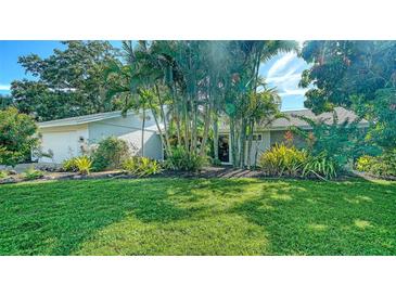 Charming home with mature landscaping and a well-manicured lawn at 3761 Countryside Rd, Sarasota, FL 34233