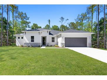 Beautiful single-story home featuring stone accents, a two-car garage, and a manicured lawn at 4008 Antelope Ter, North Port, FL 34286