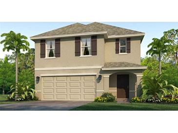 Charming two-story home with stucco exterior, complemented by a well-manicured lawn and lush tropical landscaping at 5045 Rocky Coast Pl, Palmetto, FL 34221