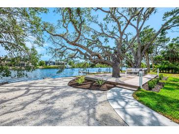 Stunning backyard oasis with deck, mature trees, and water access on the canal at 5377 Palos Verdes Dr, Sarasota, FL 34231