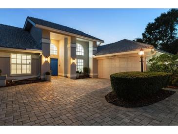 Charming single-story home with mature landscaping, paver driveway, and a welcoming blue front door at 6702 Drewrys Blf, Bradenton, FL 34203
