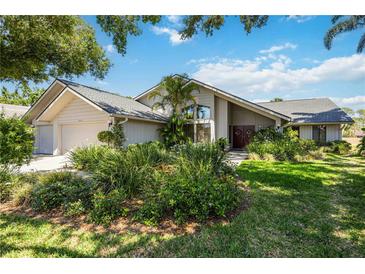 Charming home with a modern design, mature landscaping, and double door entry at 8142 Misty Oaks Blvd, Sarasota, FL 34243