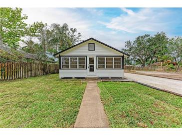 Attractive home showcasing lush lawn, gravel drive, walkway, and classic black and white color scheme, presenting curb appeal at 1016 38Th W St, Bradenton, FL 34205