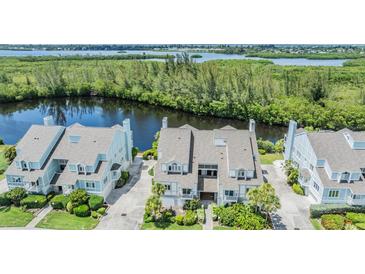 Beautifully landscaped condo with water views and gray roof; charming and well-maintained at 111 Tidy Island Blvd # 111, Bradenton, FL 34210