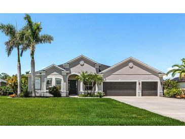 Beautiful single-story home with a manicured lawn and mature palm trees at 3015 160Th E Ter, Parrish, FL 34219