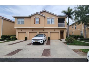 Attractive townhome with private garage, landscaped driveway, and charming architectural details at 3784 Parkridge Cir # 22-203, Sarasota, FL 34243