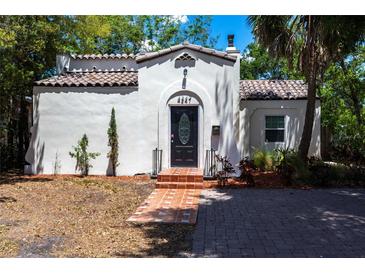 Charming Spanish-style home featuring a red-tiled roof, stucco exterior, and decorative front door with brick path at 4347 9Th N Ave, St Petersburg, FL 33713