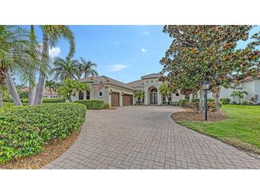 Stately home with a lush, landscaped front yard and circular driveway at 6919 Dominion Ln, Lakewood Ranch, FL 34202