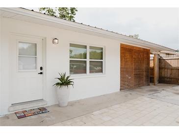 Charming home exterior with white walls, stylish lattice and a welcoming front entrance at 2300 Stratford Dr, Sarasota, FL 34232