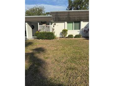 Charming home exterior featuring well-maintained landscaping and a welcoming front porch at 3921 Lakeside Rd # 168, Sarasota, FL 34232
