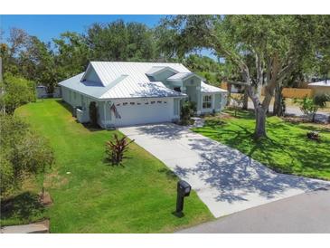 Well-maintained single Gathering home with a manicured front yard and a white metal roof at 425 46Th Nw St, Bradenton, FL 34209