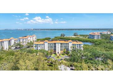 Stunning aerial shot of a waterfront condo complex with lush landscaping and beautiful blue waters at 4801 Osprey S Dr # 405, St Petersburg, FL 33711